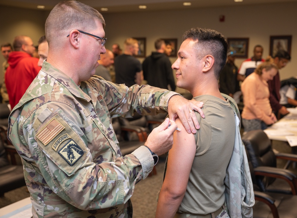 Photo of 116th Medical Group Airman administering flu vaccination to wing members