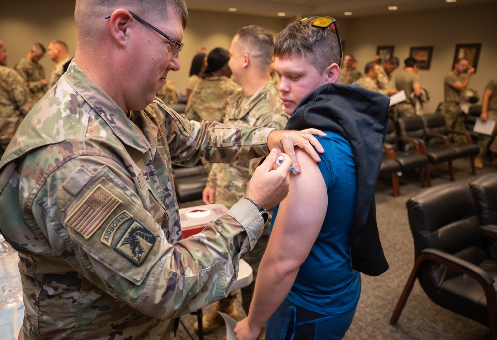 Photo of 116th Medical Group Airman administering flu vaccination to wing members