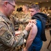 Photo of 116th Medical Group Airman administering flu vaccination to wing members