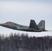 F-22s and HH-60Gs fly over JBER