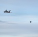 F-22s and HH-60Gs fly over JBER