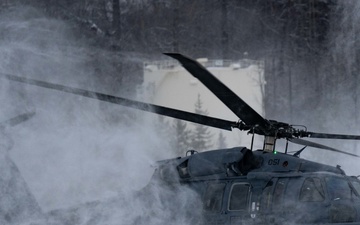 Alaska Air National Guardsmen rescue an injured snowmachiner