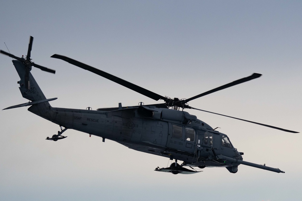 F-22s and HH-60Gs fly over JBER