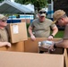 Arkansas Air National Guard members unload supplies from the USNS Comfort during Continuing Promise 2022