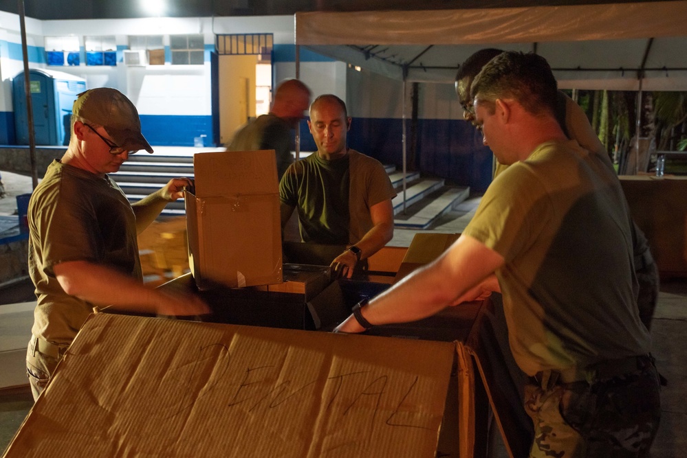 Arkansas Air National Guard members unload supplies from the USNS Comfort during Continuing Promise 2022