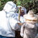 Volunteers tend to Pacific Missile Range Facility's (PMRF) Beehives