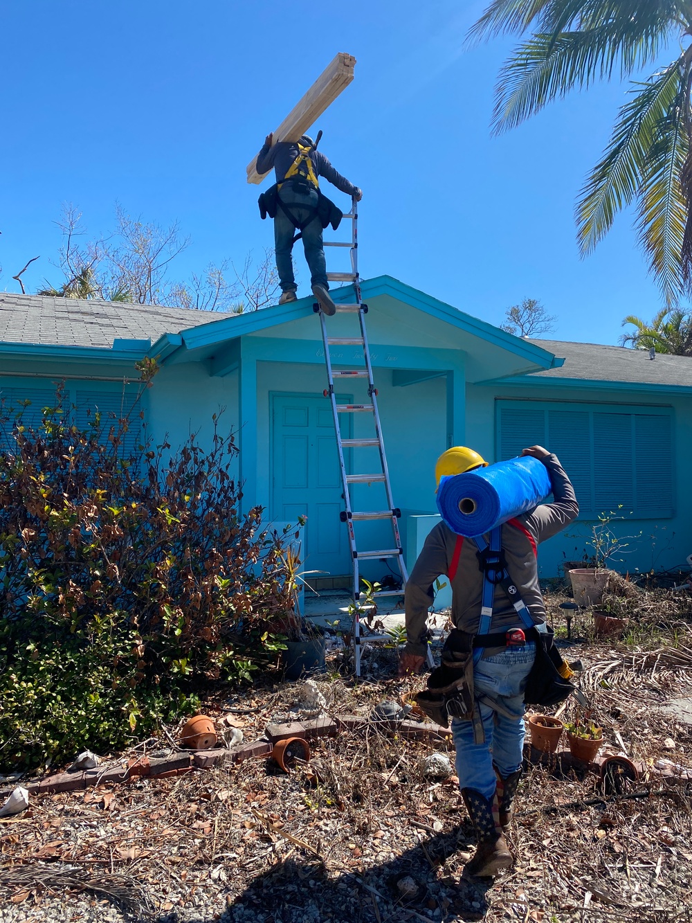 Crews Work To Install Blue Roofs as Part of the Army Corps of Engineers Operation Blue Roof