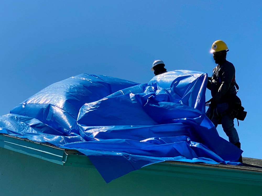 Crews Work To Install Blue Roofs as Part of the Army Corps of Engineers Operation Blue Roof