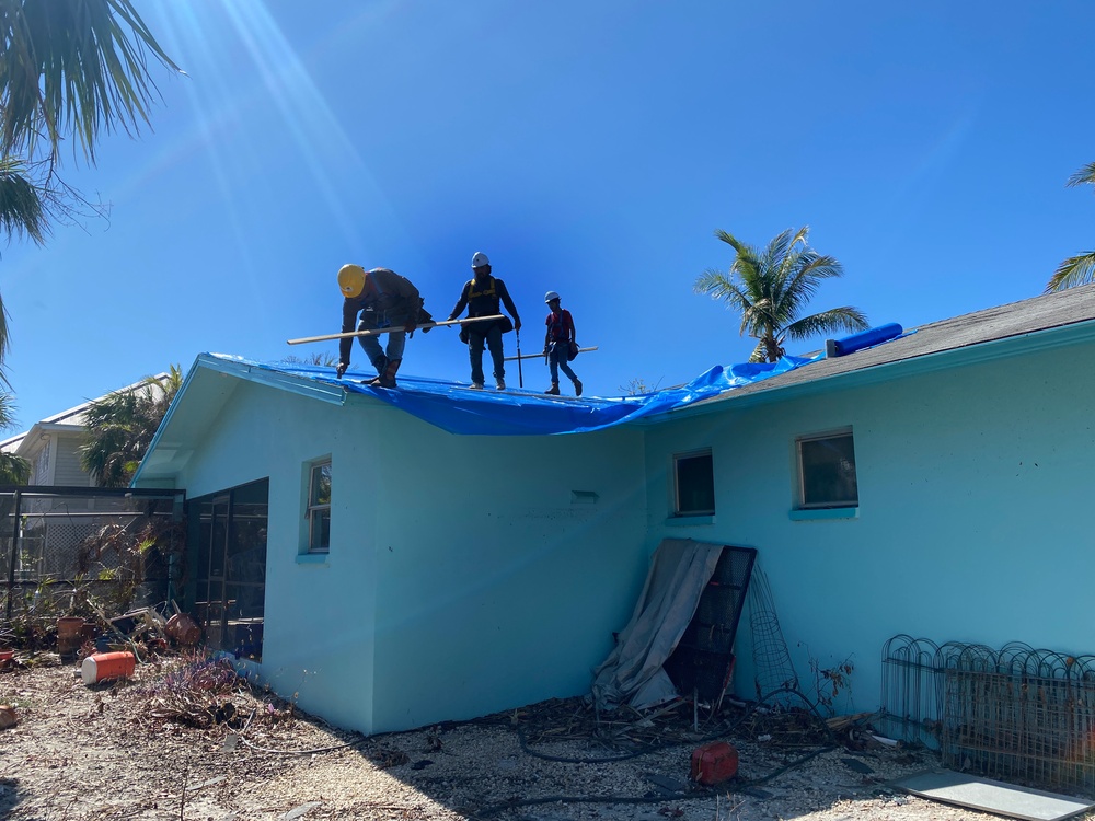 Crews Work To Install Blue Roofs as Part of the Army Corps of Engineers Operation Blue Roof