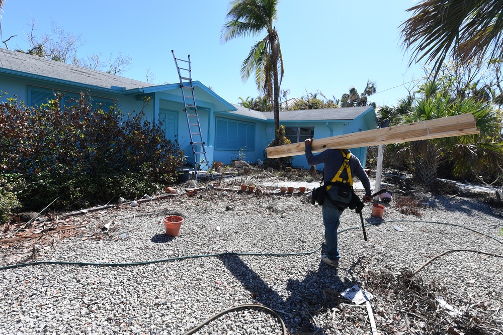 Crews Work To Install Blue Roofs as Part of the Army Corps of Engineers Operation Blue Roof