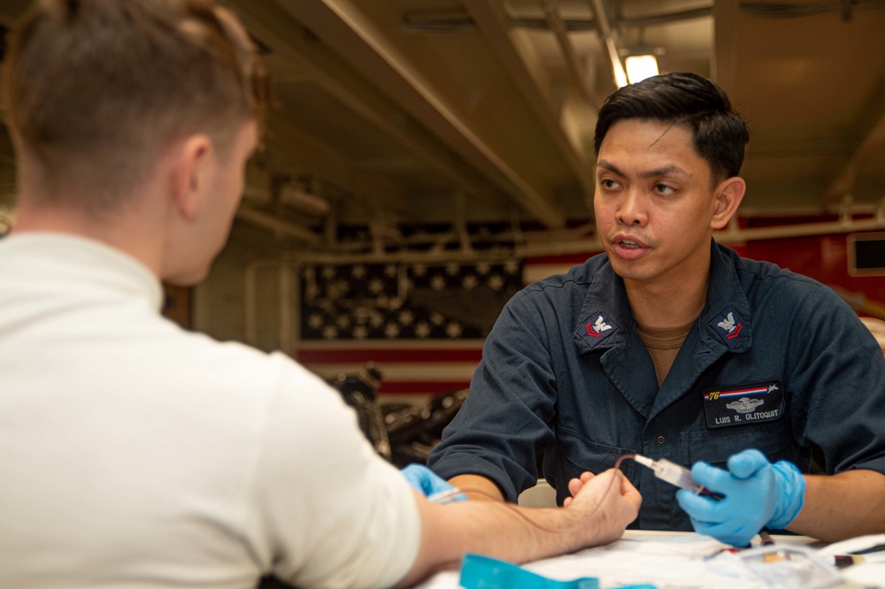 USS Ronald Reagan (CVN 76) Sailors administer and receive flu shots and blood tests