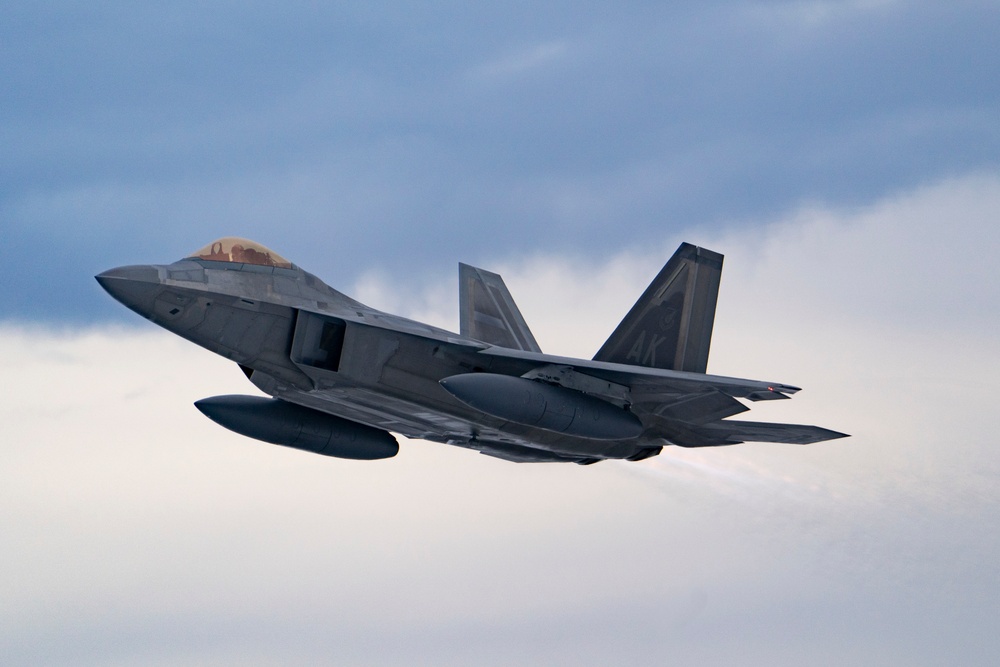 F-22s fly over JBER