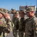 Soldiers get coins from 1st Signal Brigade command team