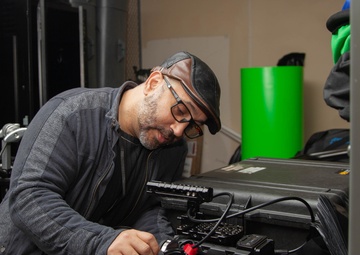 Camera Man Preps Equipment for Military Spirit Week