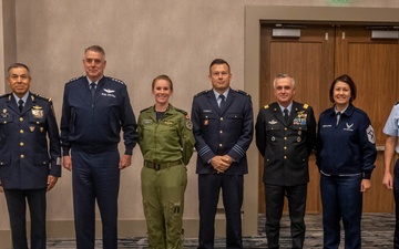 AMC Commander Gen. Mike Minihan and CMSAF JoAnne Bass engage with international partners during the Airlift/Tanker Association Symposium