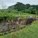 Seabees with Naval Moblie Construction Battalion 4, Mariens with 31st Marine Expeditionary Unit come together with Filipino Seabees in leveling out a small access path in Crow Valley.