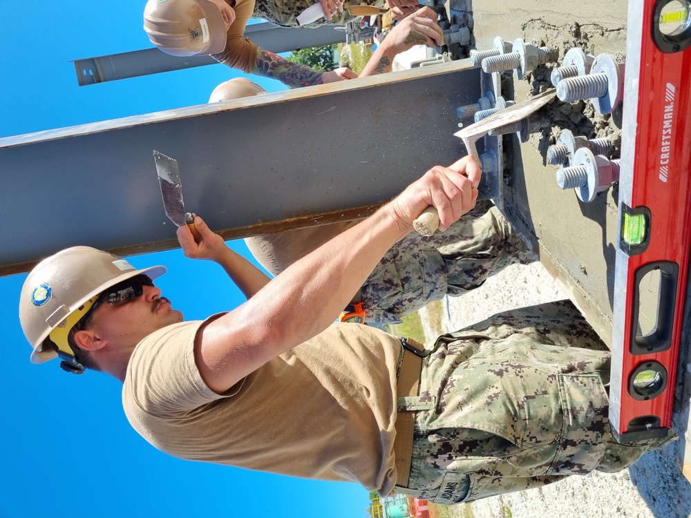 Builder 2nd Class Ethan Adams, prepares concrete for Gas Cylinder Storage 19-851.