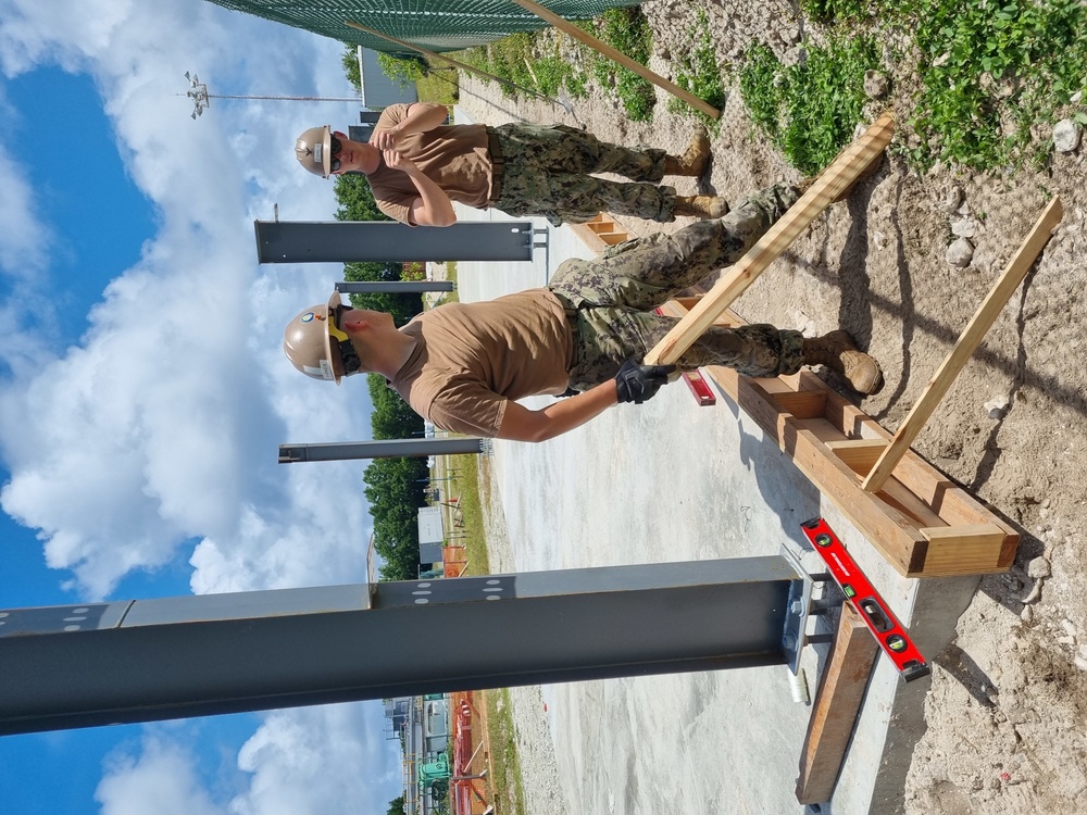 Utiliesman 2nd Class Jonathan Dunn and Construction Mechanic 3rd Class Christian Parker with Naval Mobile Construction Battalion (NMCB 4), preparing columns for concrete pour.