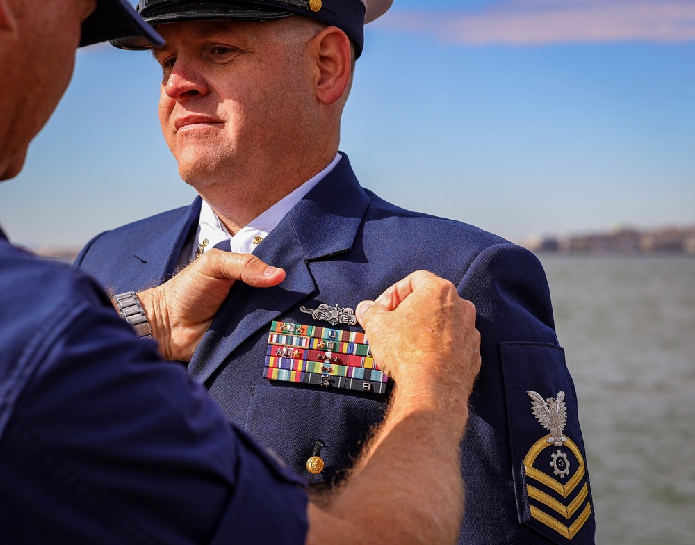 Coast Guard Chief Petty Officer Richard Gauthier is presented the permanent cutterman pin.