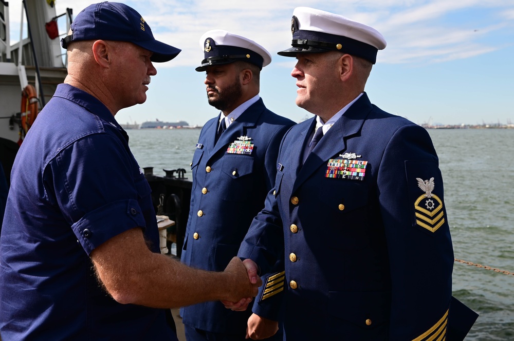 U.S. Coast Guard Chief Machinery Technician Richard Gauthier and Chief Culinary Specialist Tristen Davis receive the permanent cutter man insignia.