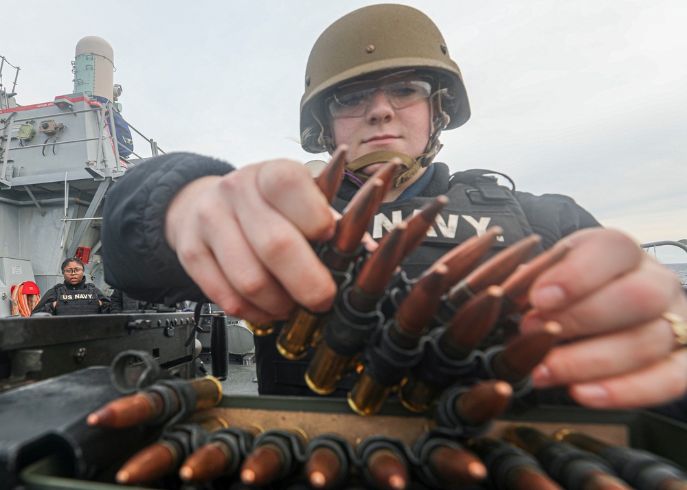Sailor Reloads Machine Gun