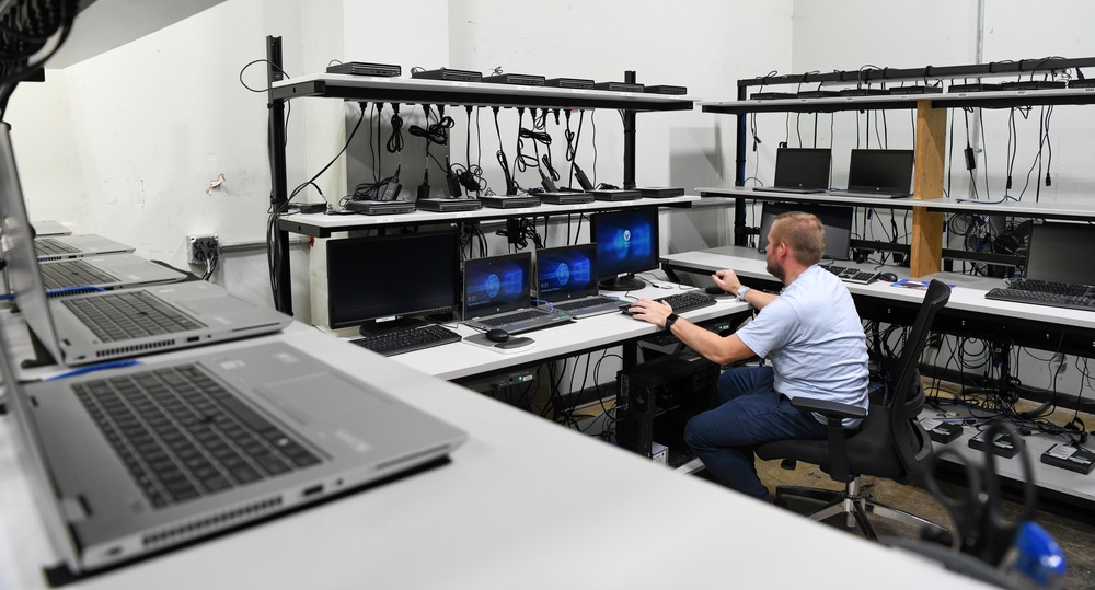 Technicians replacing computers base wide