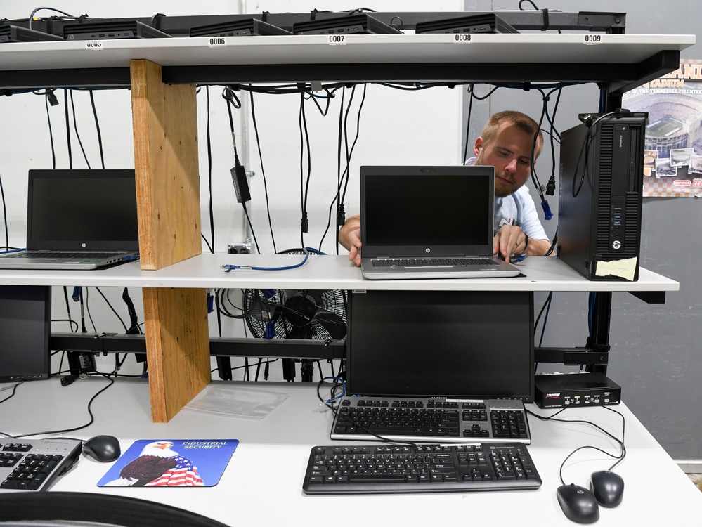 Technicians replacing computers base wide