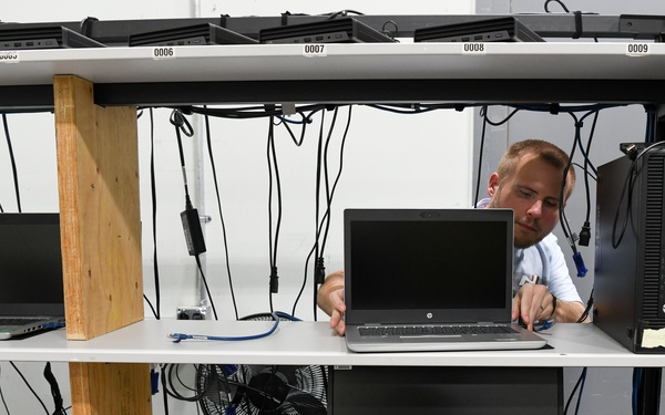 Technicians replacing computers base wide