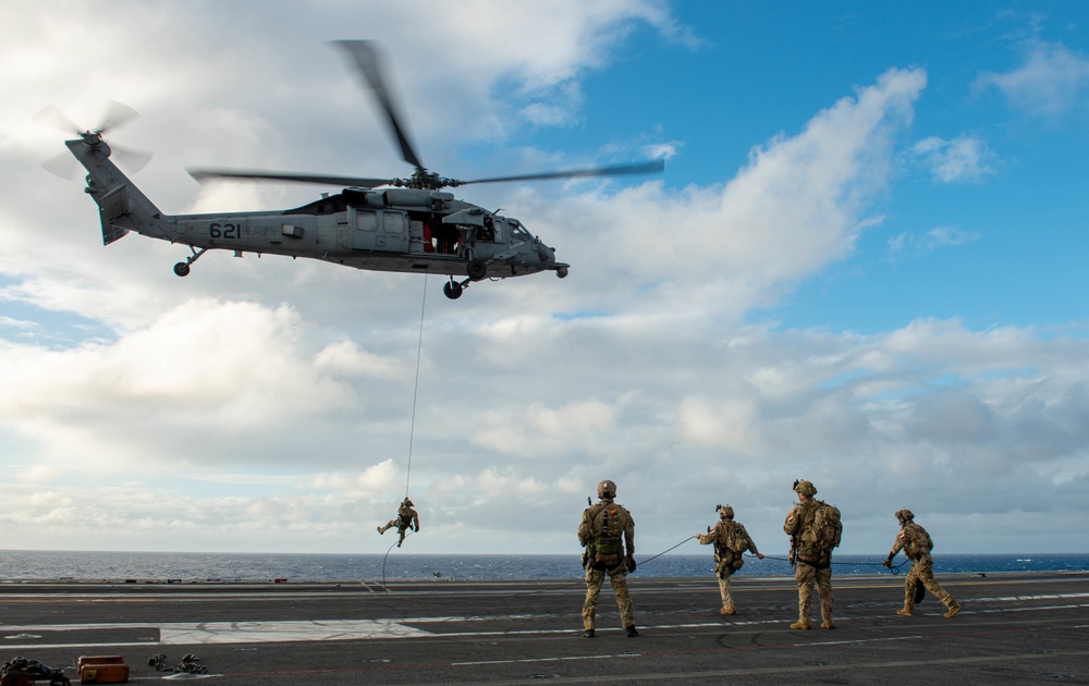 Explosive Ordnance Disposal Mobile Unit 5 conducts maritime interdiction training with Helicopter Sea Combat Squadron (HSC) 12