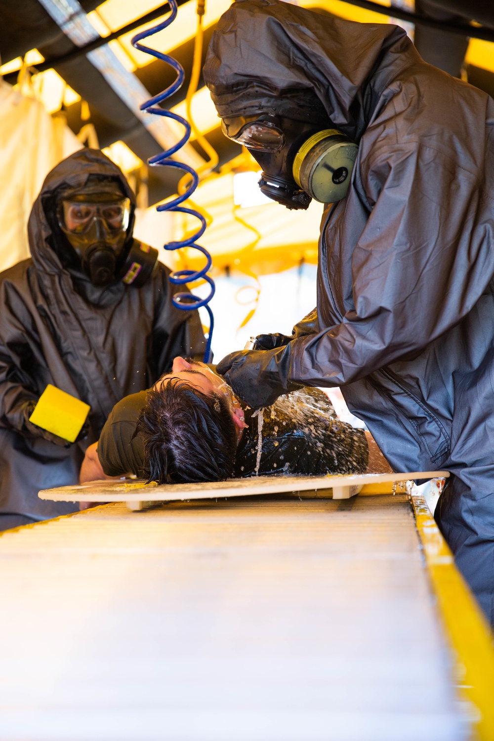 Marine CBIRF members conducts decontamination rinsing during Exercise Vista Forge