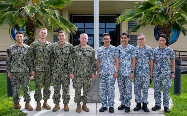 U.S. and Republic of Singapore Navy (RSN) pose for a photo at Commander, Submarine Squadron 15, during the 4th RSN and U.S. Navy Submarine Force Staff Talks