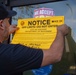 A special agent from Homeland Security Investigations (HSI) places an off limits sign on the location that was investigated by HSI as part of a stolen pharmaceutical ring during Operation Boiling Point