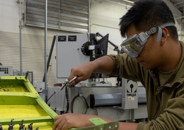 Maintenance Airmen repair APU doors
