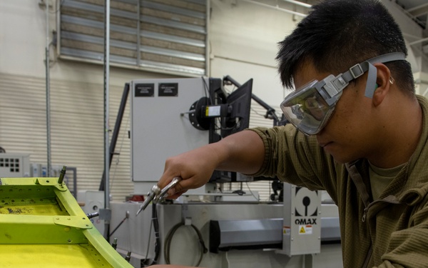 Maintenance Airmen repair APU doors