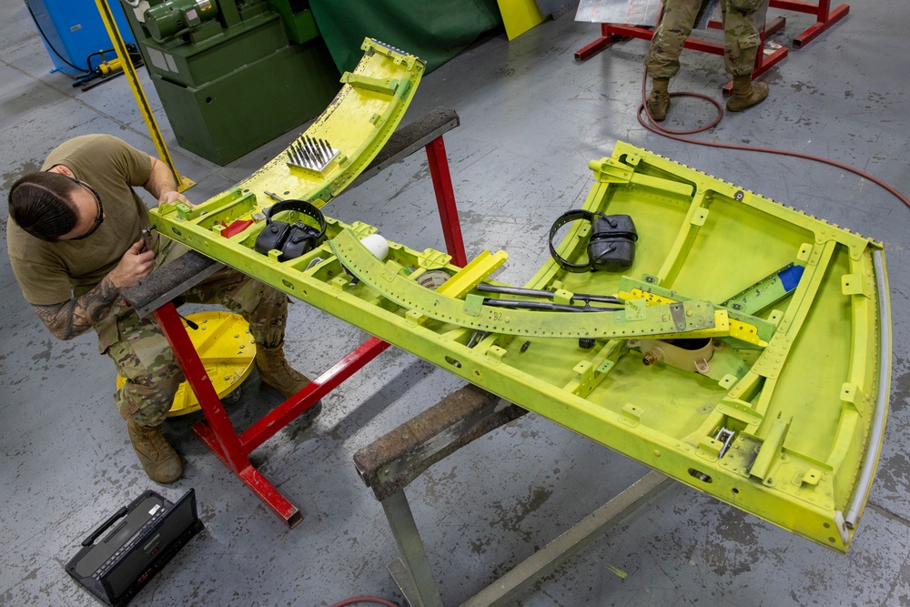 Maintenance Airmen repair APU doors