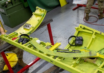 Maintenance Airmen repair APU doors