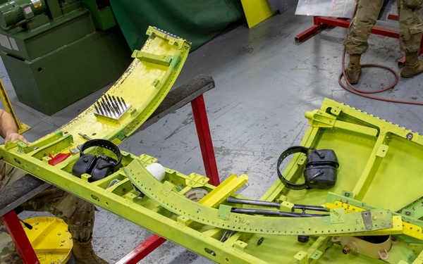 Maintenance Airmen repair APU doors