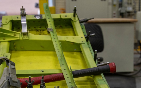 Maintenance Airmen repair APU doors