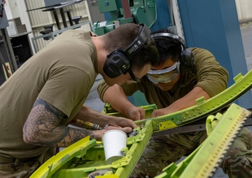 Maintenance Airmen repair APU doors
