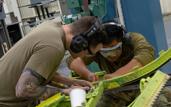 Maintenance Airmen repair APU doors