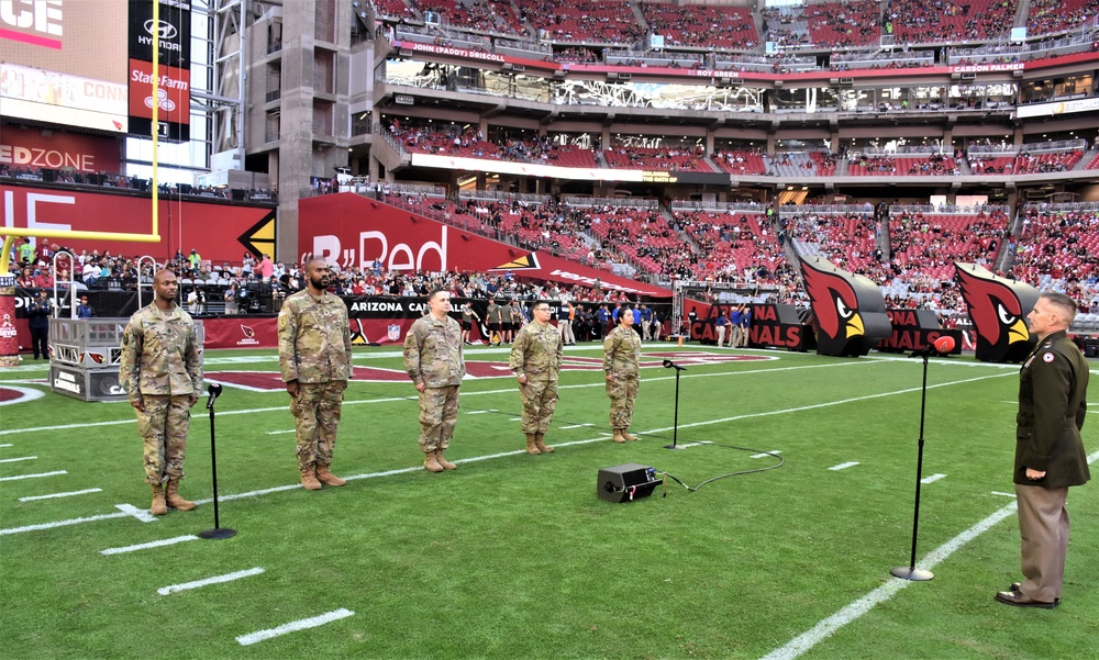 653rd RSG commander conducts reenlistment ceremony at NFL game