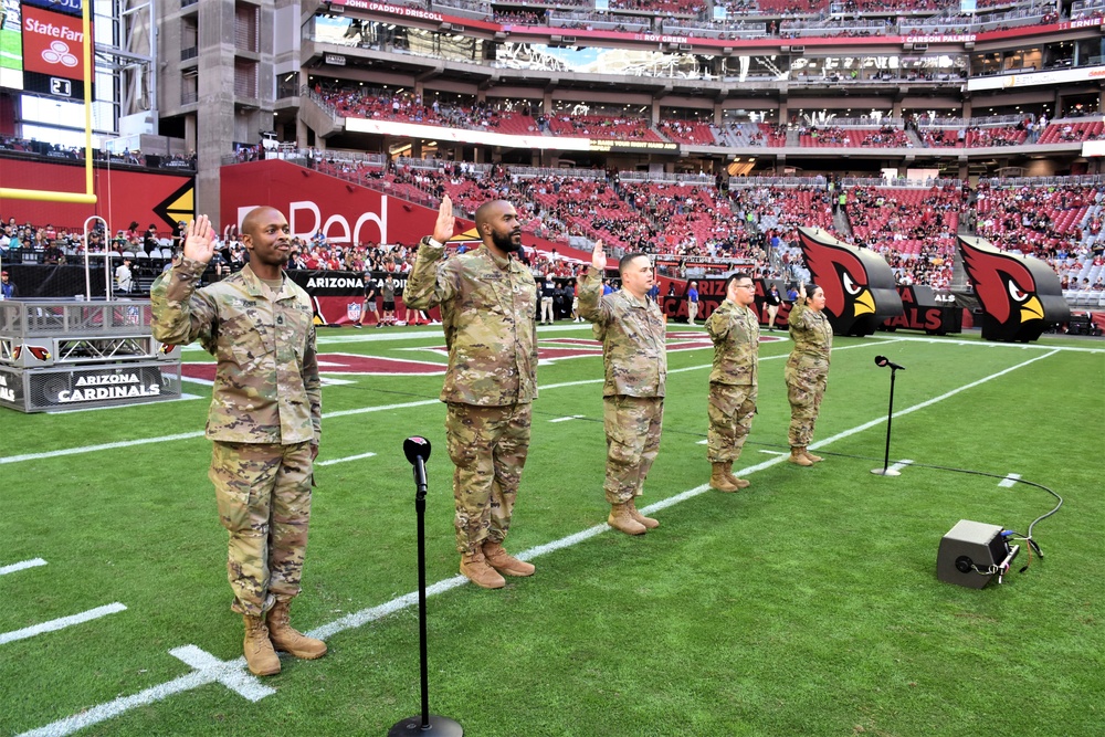 653rd RSG commander conducts reenlistment ceremony at NFL game