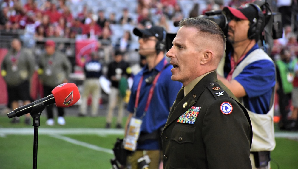 653rd RSG commander conducts reenlistment ceremony at NFL game