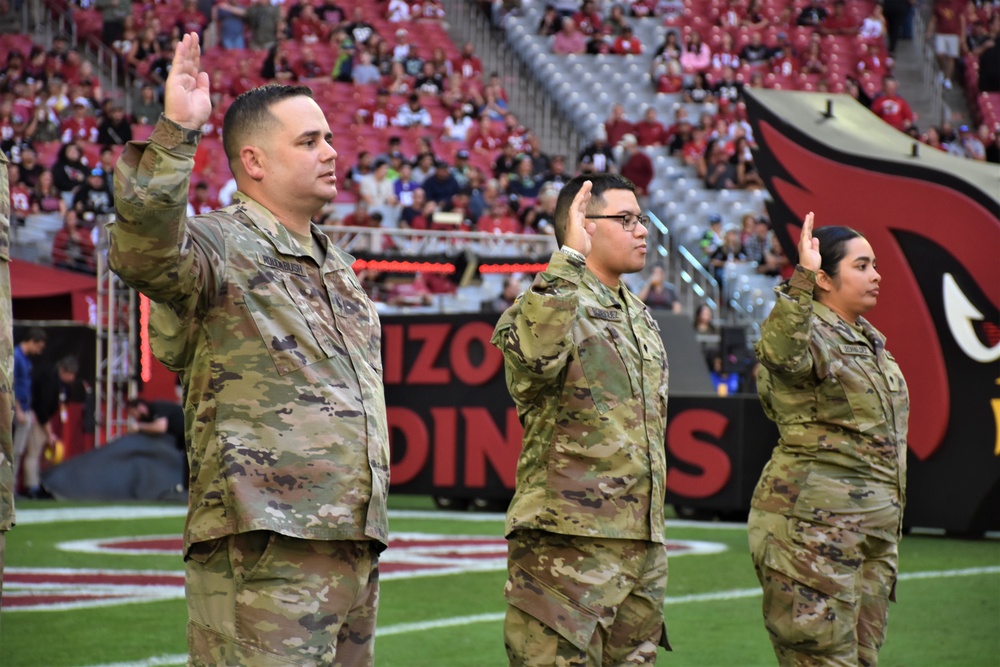 653rd RSG commander conducts reenlistment ceremony at NFL game