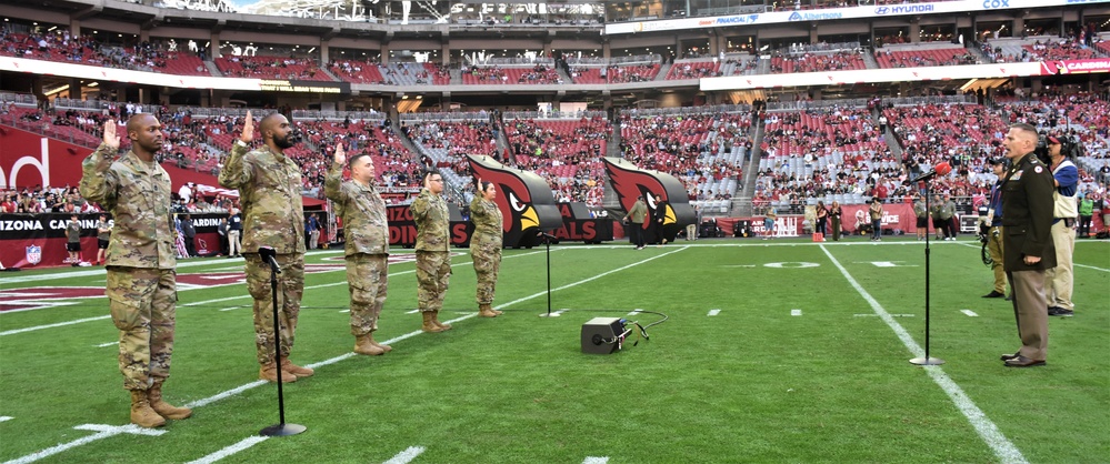 653rd RSG commander conducts reenlistment ceremony at NFL game