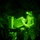 TACP Lightning Challenge 2022 A night vision image showing a military personnel in camouflage uniform handling what appears to be an ammunition canister or equipment container near a weapons system or vehicle-mounted equipment. The image is captured through a night vision device, rendering everything in characteristic green monochrome. A small light source is visible on the soldier's head, likely a night-vision-compatible headlamp.