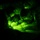 TACP Lightning Challenge 2022 The image is captured through night vision optics, showing two military personnel in camouflage uniforms examining a map under low-light conditions. The distinctive green monochromatic glow is characteristic of night vision photography or imaging equipment. The subjects appear to be engaged in tactical navigation or mission planning during nighttime operations.
