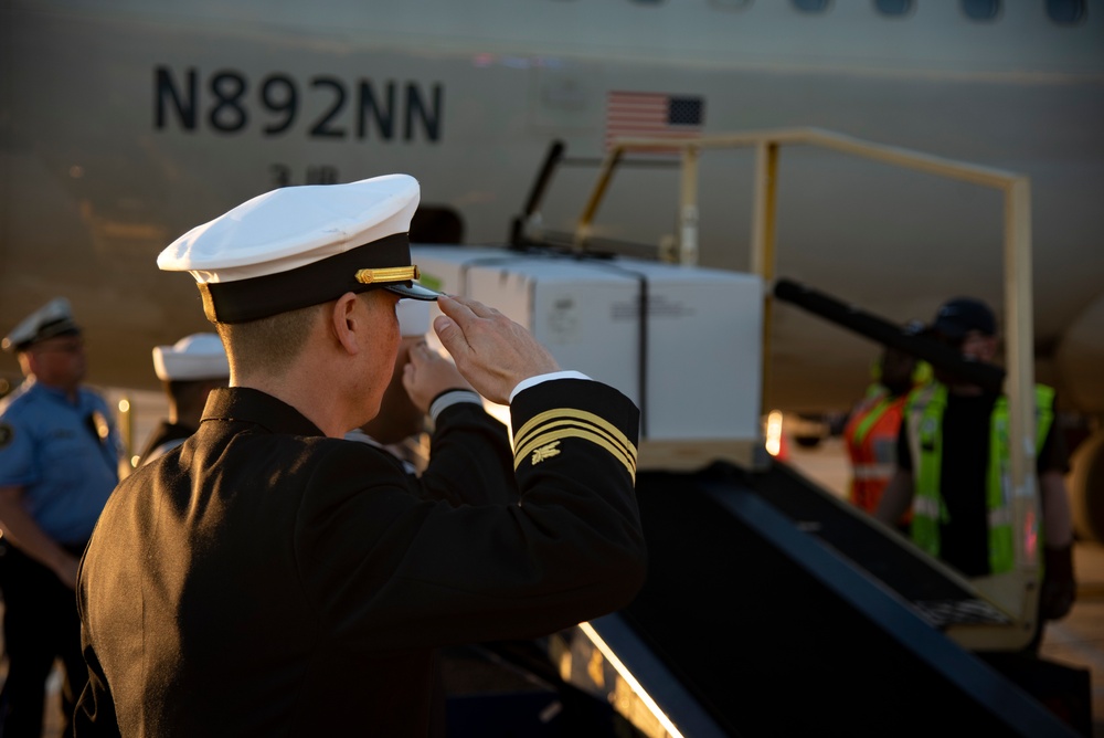 Sailors transfer the remains of Radioman 3rd Class Charles A. Montgomery into a hearse bound for his final resting place.