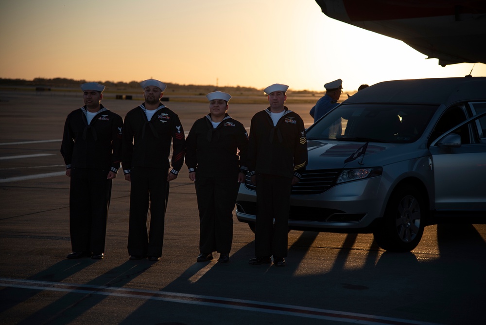 Funeral Honors Detail stand guard over the remains of Radioman 3rd Class Charles A. Montgomery's they are secured for transport in a hearse bound for his final resting place.