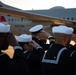 Sailors render a salute during the dignified transfer of remains of Radioman 3rd Class Charles A. Montgomery.